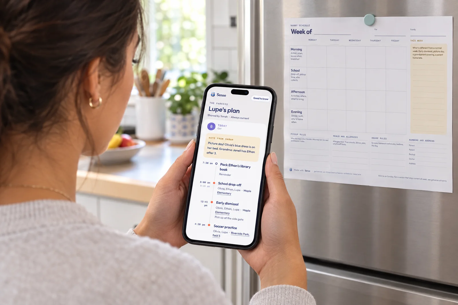 A nanny in a bright kitchen reads Lupe's plan on her phone, a picture-day note from Sarah above the school run, beside a printed weekly nanny schedule on the fridge