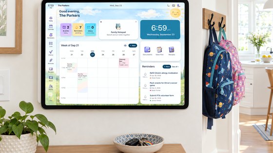 Sense Hub on a wall-mounted tablet by the kitchen doorway, showing the family's week, reminders, and today's plan